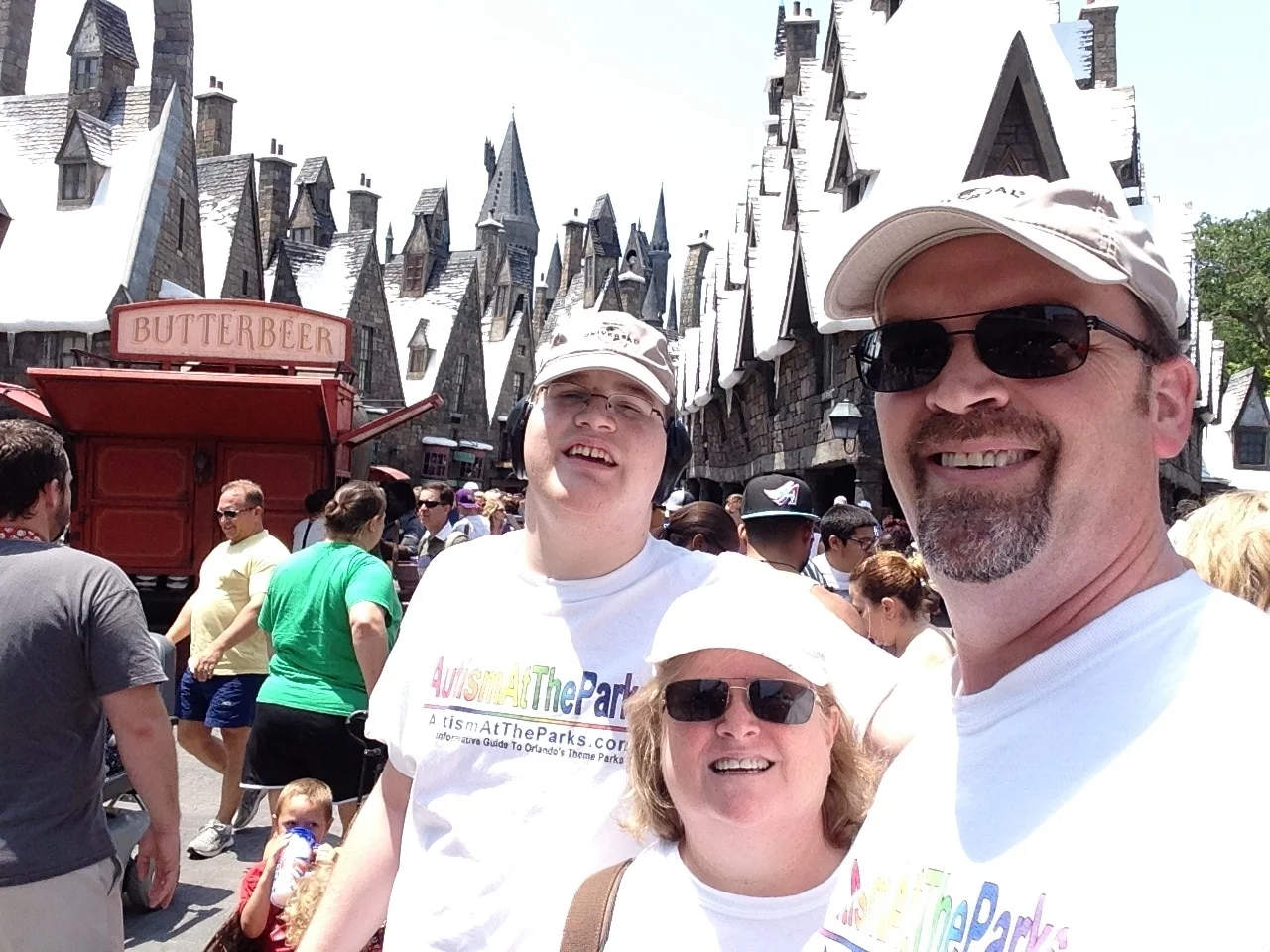 Maureen, Phil, and Zachary in The Wizarding World of Harry Potter - Hogsmeade in Universal Orlando. Copyright AutismAtTheParks.com. All rights reserved. 