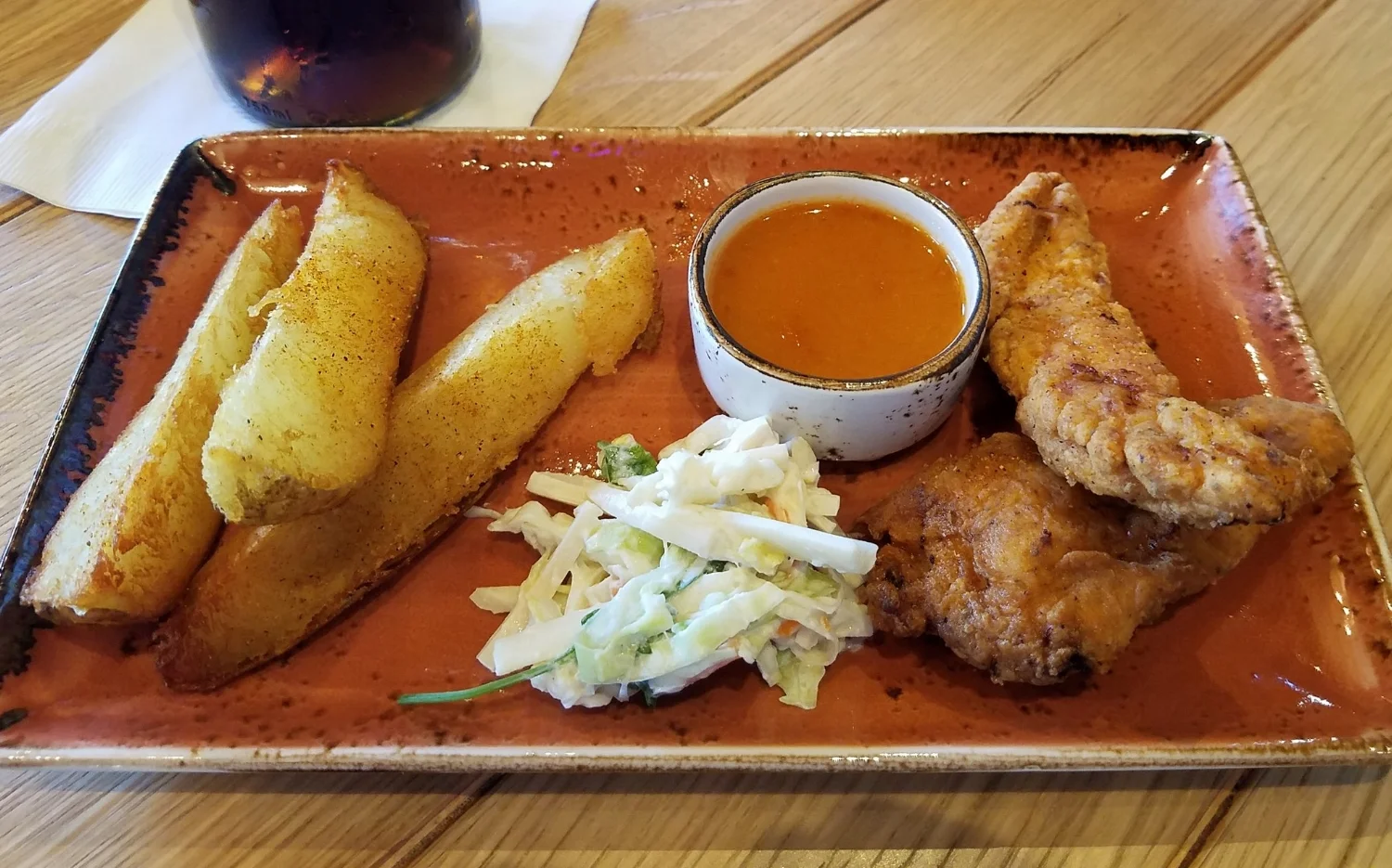 Buttermilk Fried Chicken Tenders, Steak Fries, and Cabbage Slaw at Strong Water Tavern.