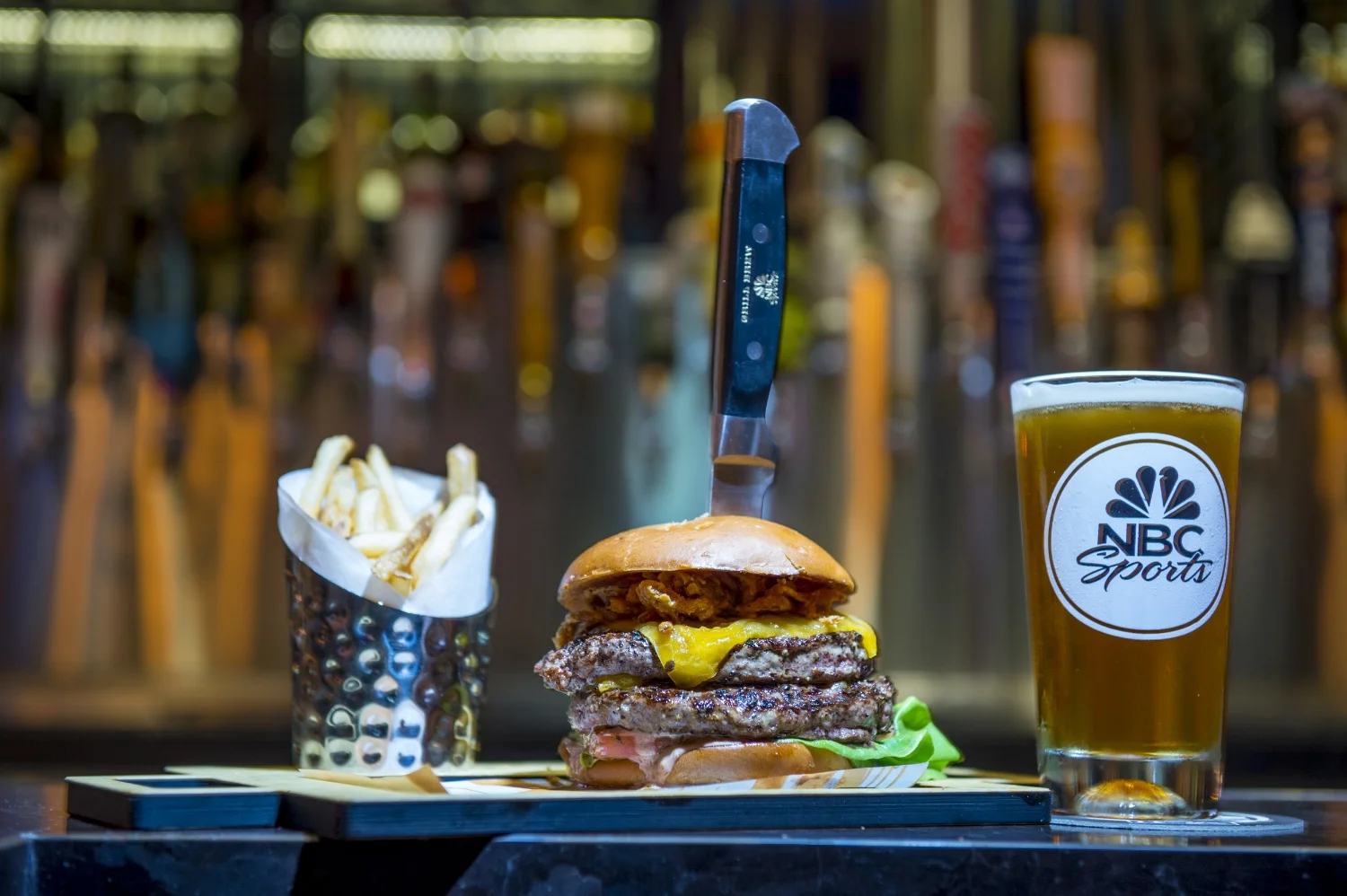 Grand Slam Burger, Fries, and Beer from NBC Sports Grill and Brew. Image credit: Universal Orlando Resort.