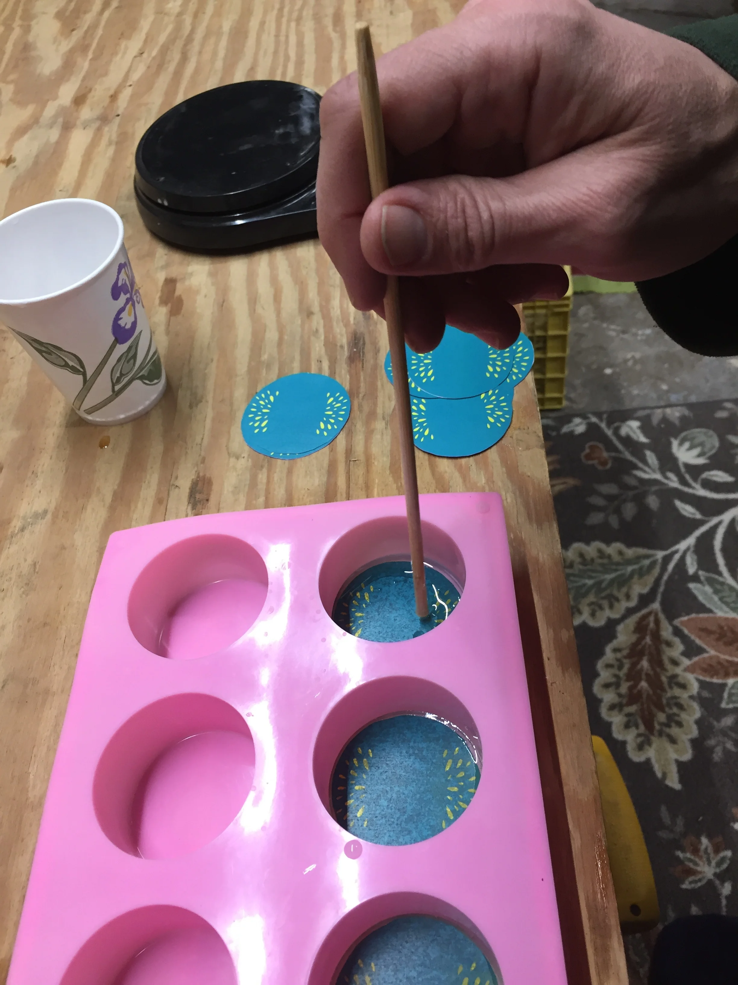 placing paper on the back of the Turtle Timer in the mold with a stick