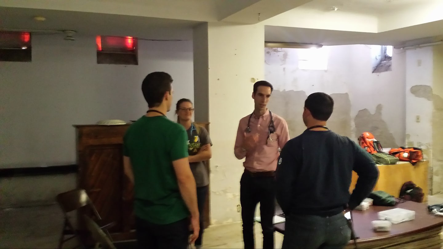 Talking with a group of medical students while volunteering with Street Medicine Detroit at St. Peter's Episcopal Church in the Corktown Neighborhood of Detroit, Michigan. 