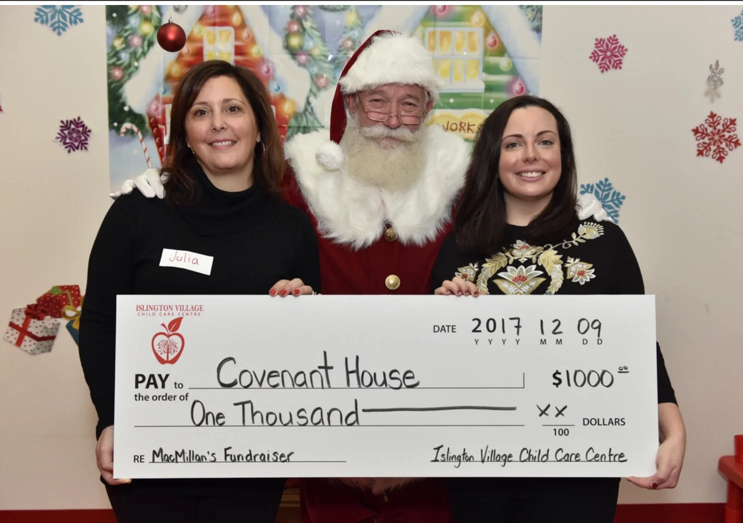 Islington Village Child Care Centre Director Julia Meffe, Santa Claus and Meghan from Covenant House Toronto.