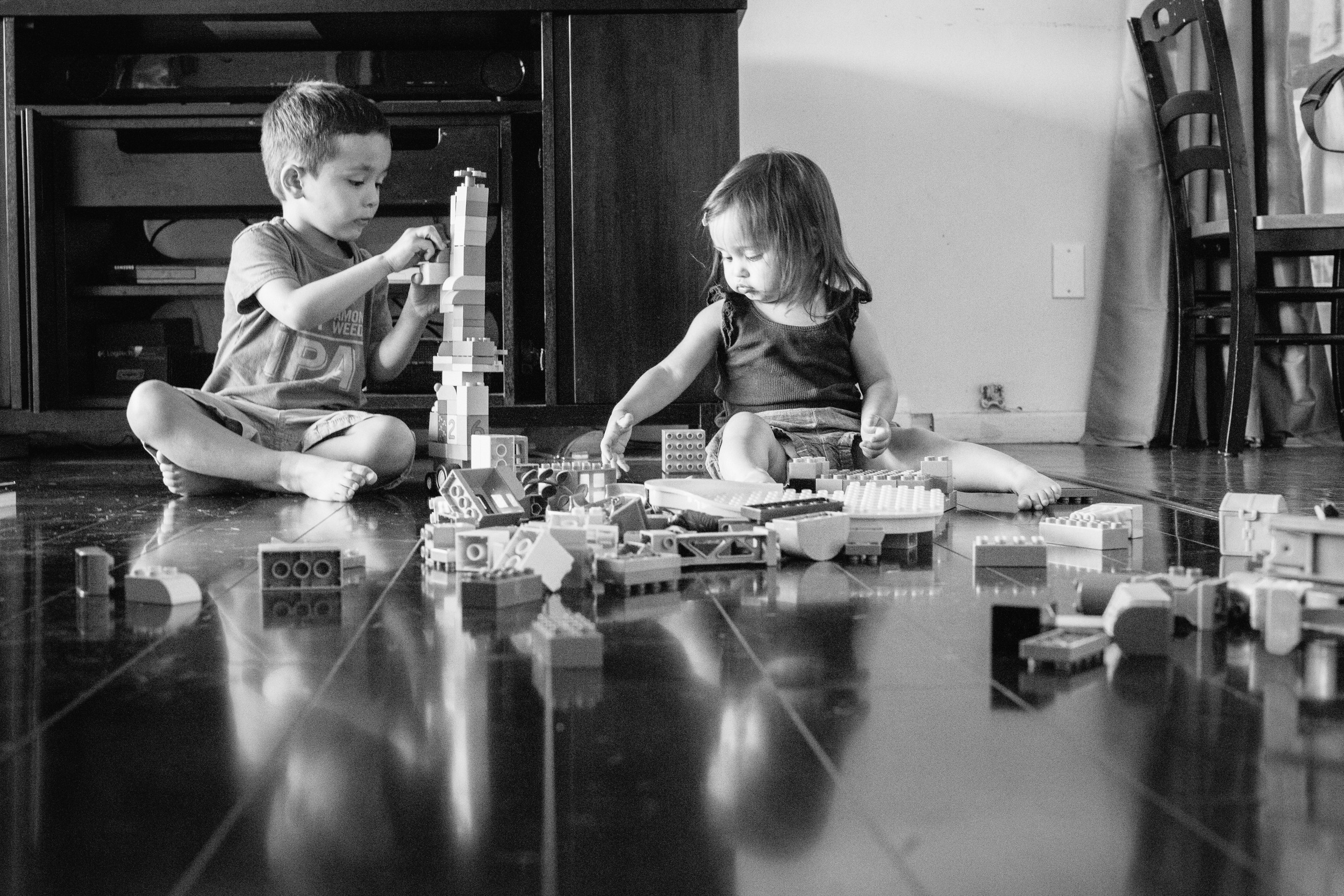 Children playing with Legos. Photo taken down low on the ground.