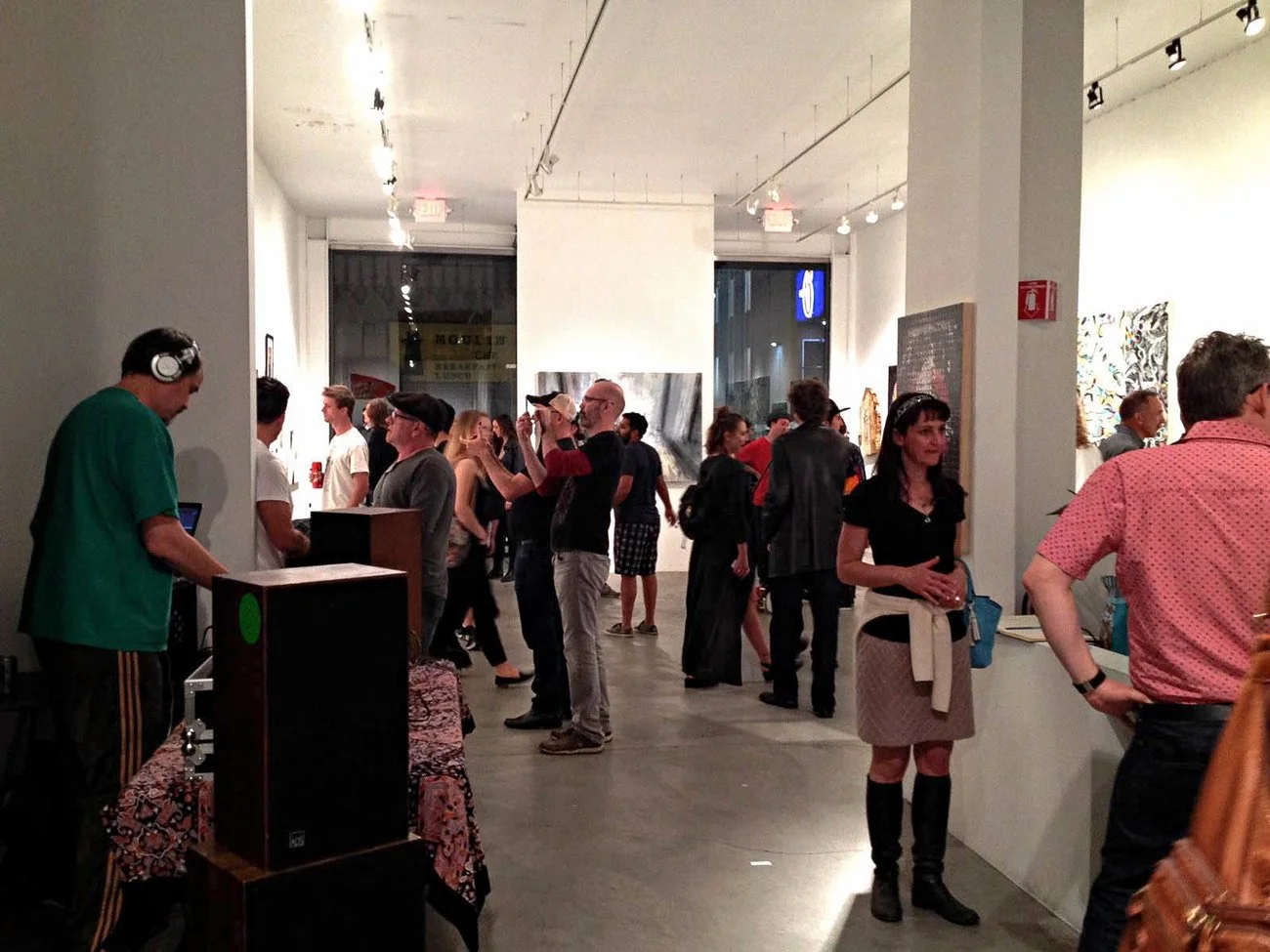 Exhibition opening view of Dawning by Tibor Simon-Mazula at White Walls Gallery, San Francisco, showing visitors engaging with contemporary figurative paintings exploring presence, distance, and quiet human tension.