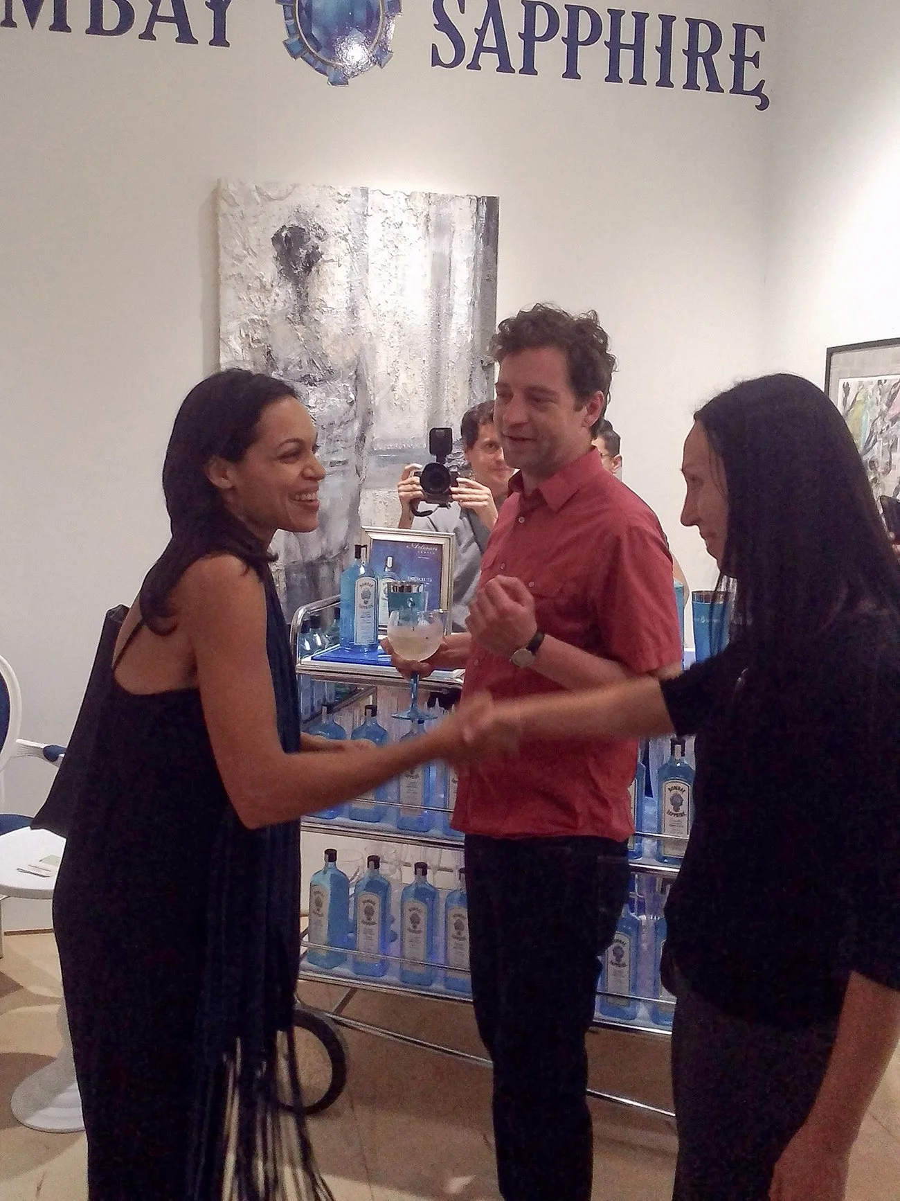Artist present during a friendly moment between invited guests within the exhibition space at SCOPE Miami Beach