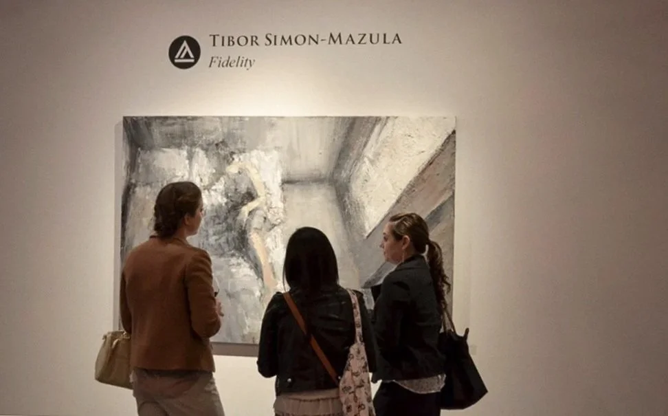 Visitors engaging closely with a painting from Fidelity by Tibor Simon-Mazula, highlighting scale, intimacy, and focused looking within a San Francisco gallery.