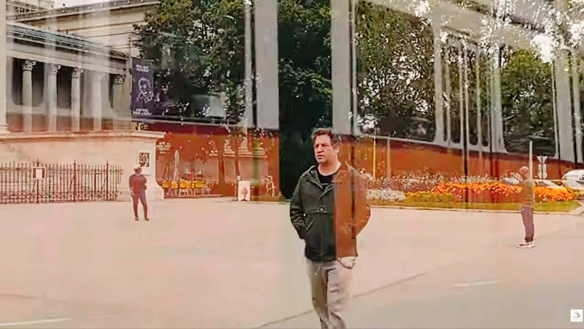 Tibor Simon-Mazula walking through urban space, cinematic still from exhibition-related film work