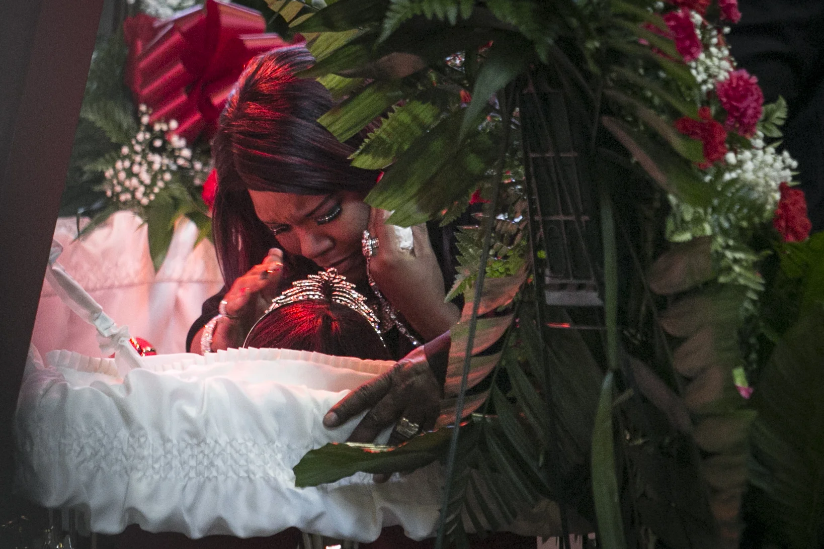  Latasha Jones kisses her mother, Bettie Jones, during her funeral at New Mount Pilgrim Missionary Baptist Church, Wednesday, Jan. 6, 2016. A Chicago Police officer responding to a domestic dispute between Bettie Jones' neighbor and his 19-year-old son, Quintionio LeGrier, opened fire the day after Christmas, killing both LeGrier and the 55-year-old mother of five. Police said LeGrier was armed with a bat, but Jones was accidentally killed in the shooting. | Ashlee Rezin Garcia/Sun-Times    Mourners remember mother of five 'accidentally' shot by police   