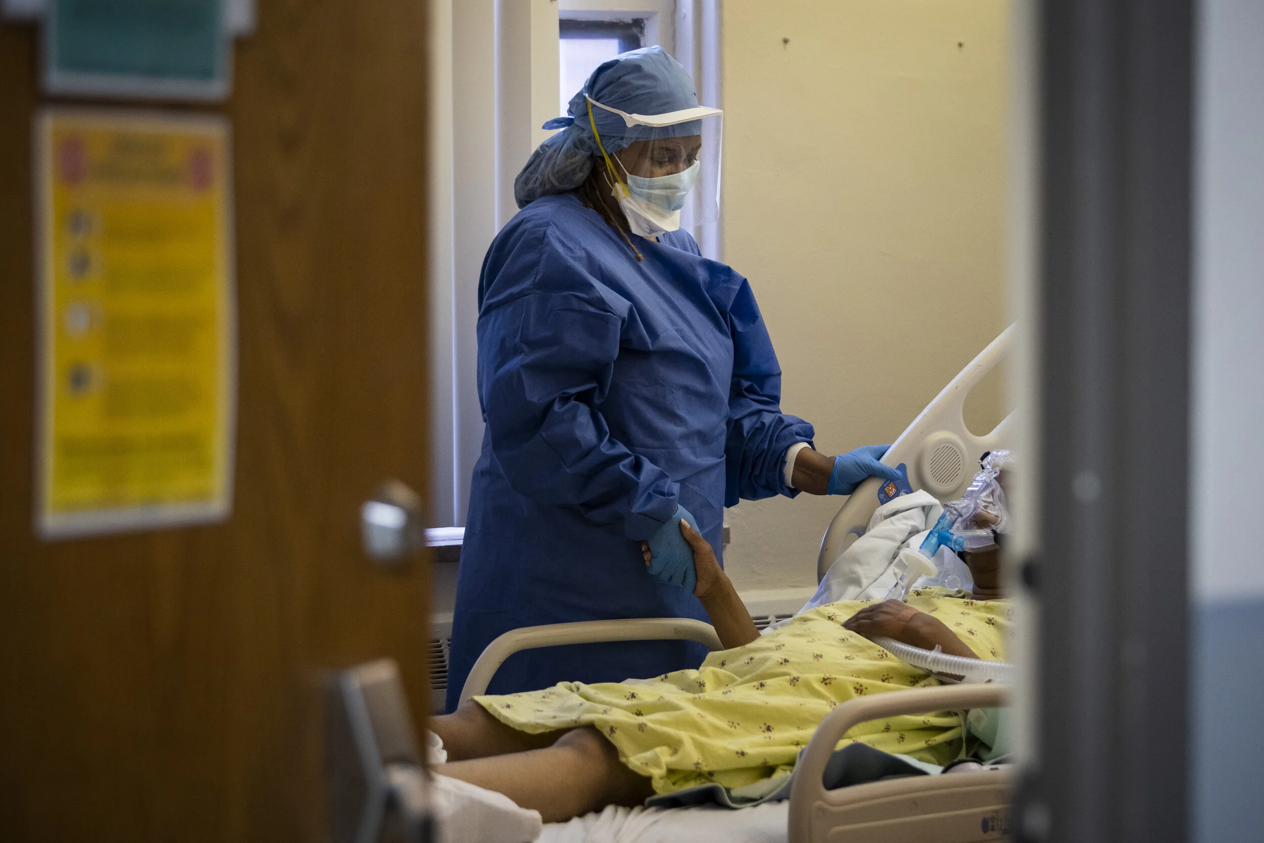  Nurse Jeanette Averett comforts a 56-year-old woman with COVID-19 who was struggling with anxiety because of her non-invasive ventilator at Roseland Community Hospital on the Far South Side, Tuesday afternoon, April 28, 2020.   During the standard 1