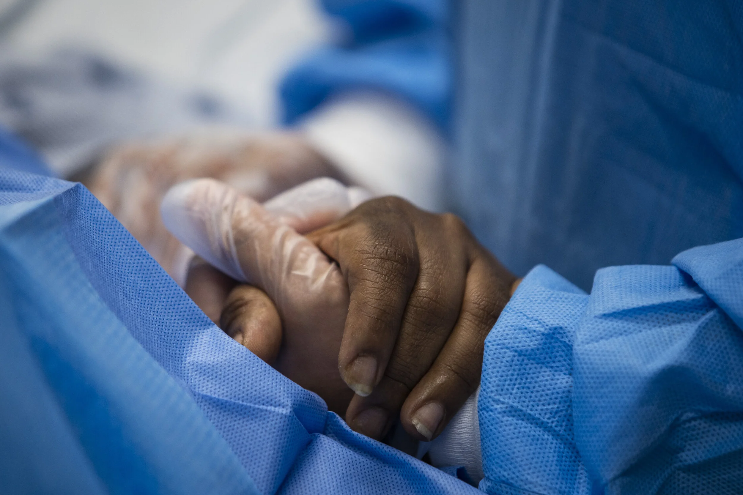  Nurse practitioner Capri Reese talks to a patient and holds her hand while a doctor administers an IV at Roseland Community Hospital on the Far South Side, Tuesday afternoon, April 28, 2020.   During Reese’s standard 12-hour shift Tuesday, she respo