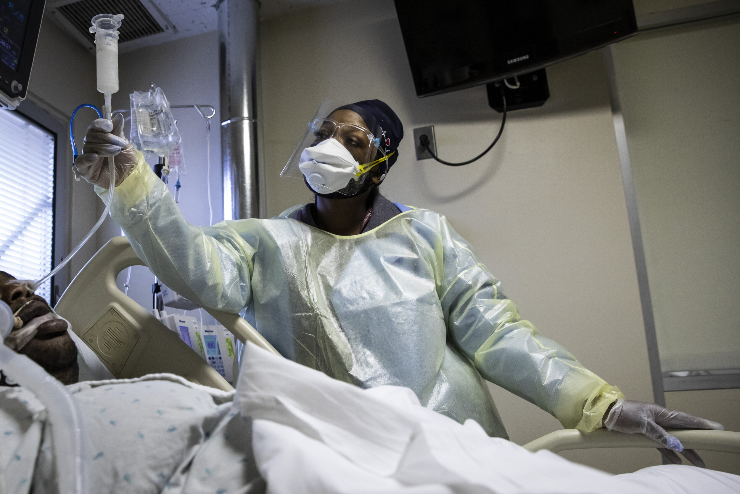  Nurse Jessica Bell administers sedative medication for a man with COVID-19 and on a ventilator in the Intensive Care Unit at Roseland Community Hospital on the Far South Side, Tuesday afternoon, Dec. 8, 2020.   “With COVID, you can decline quickly. 