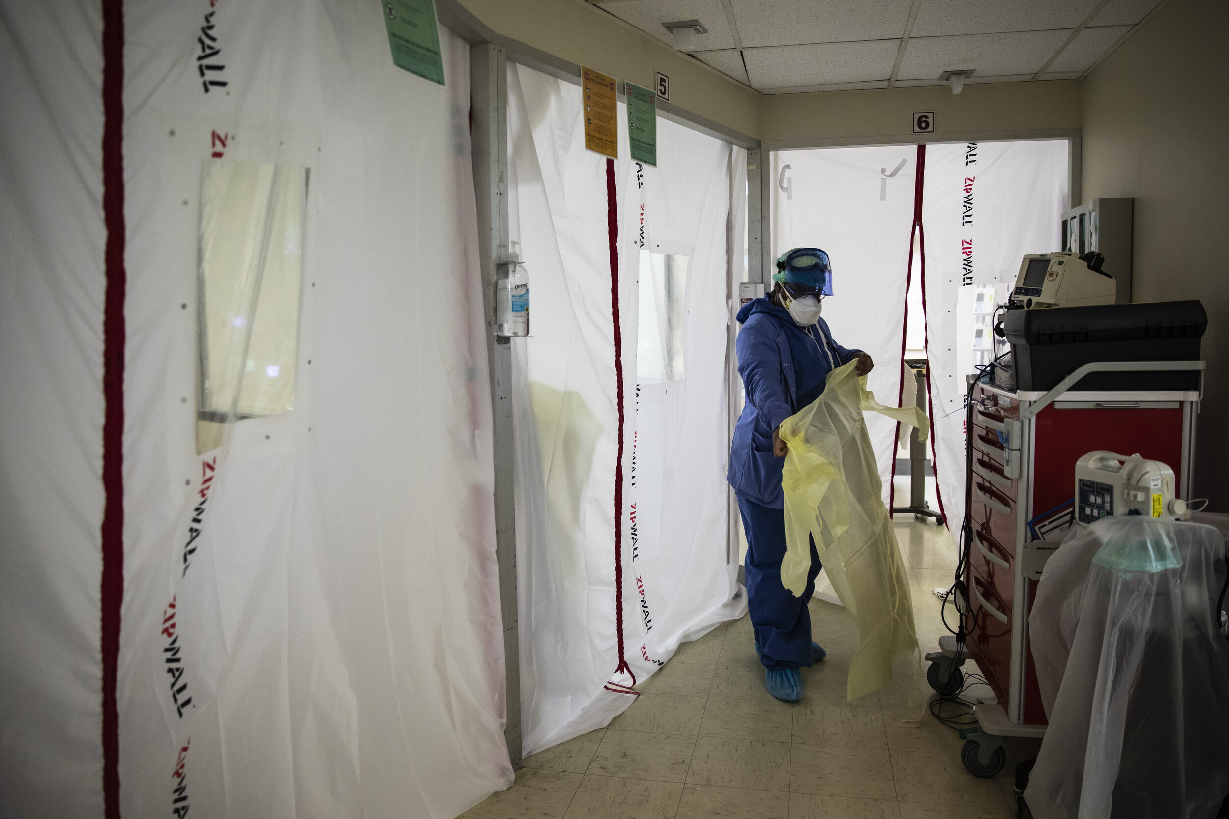  Nurse Tamara Jones puts on new personal protective equipment as she prepares to check on a patient with COVID-19 in the Intensive Care Unit at Roseland Community Hospital on the Far South Side, Tuesday afternoon, Dec. 8, 2020.   Zip walls and negati