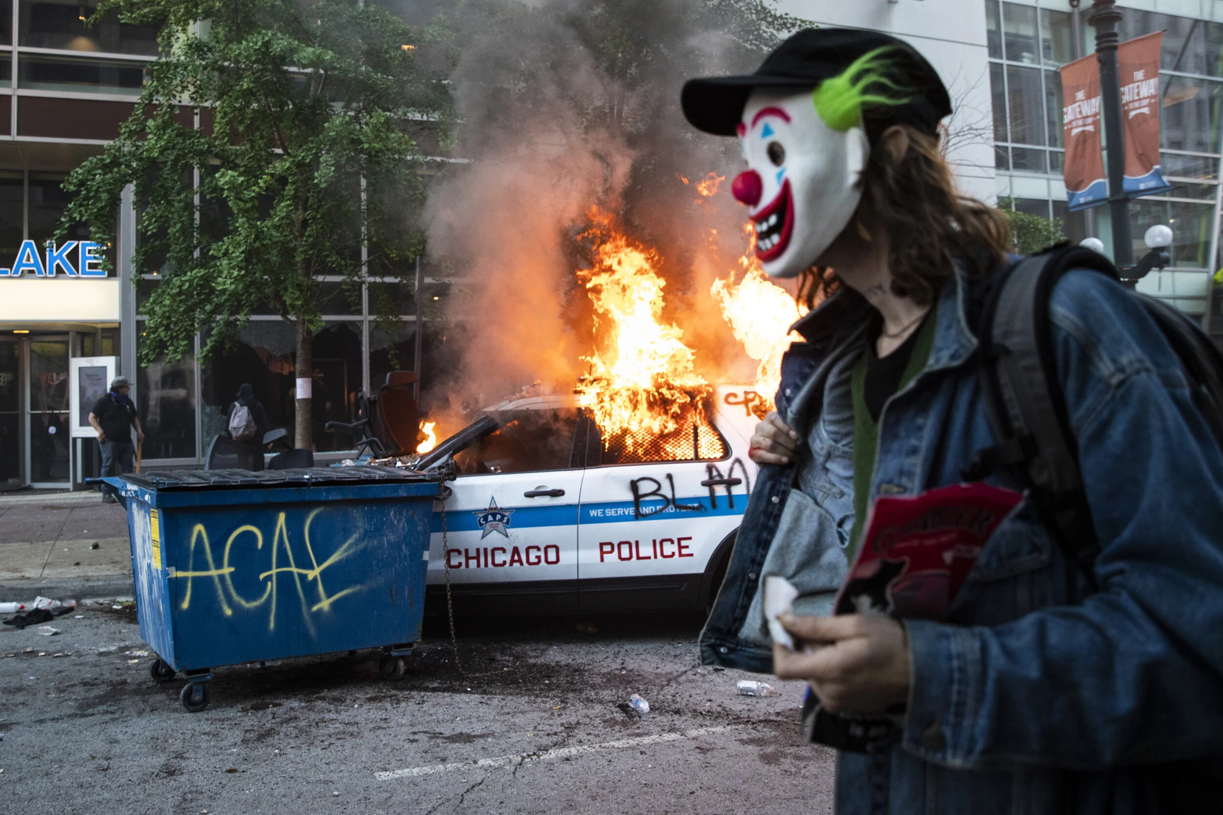  A masked man walks past a burning Chicago Police Department SUV near State and Lake in the Loop as thousands of protesters in Chicago joined national outrage over the killing of George Floyd in Minneapolis police custody, May 30, 2020. Federal prose