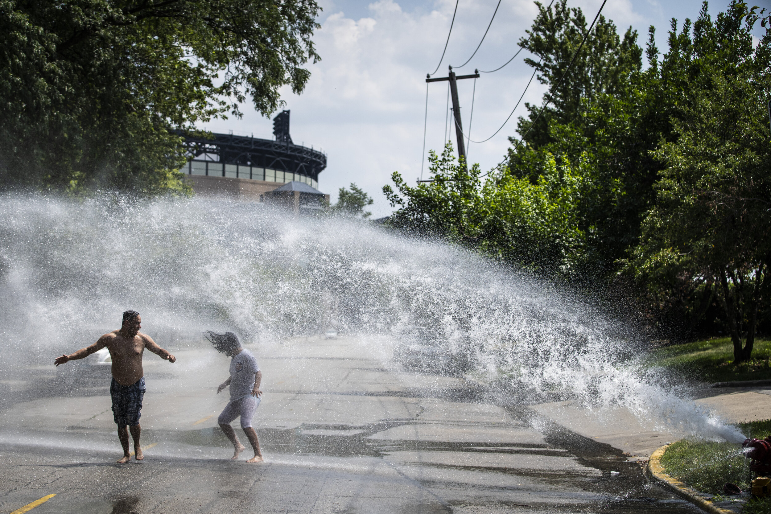  With temperatures in the 80s, Chicagoans Steven Gomez, 40, and his 9-year-old daughter, Hannah Gomez, cool off in the water from an open fire hydrant near Guaranteed Rate Field in the Bridgeport neighborhood on the city's South Side, Thursday aftern