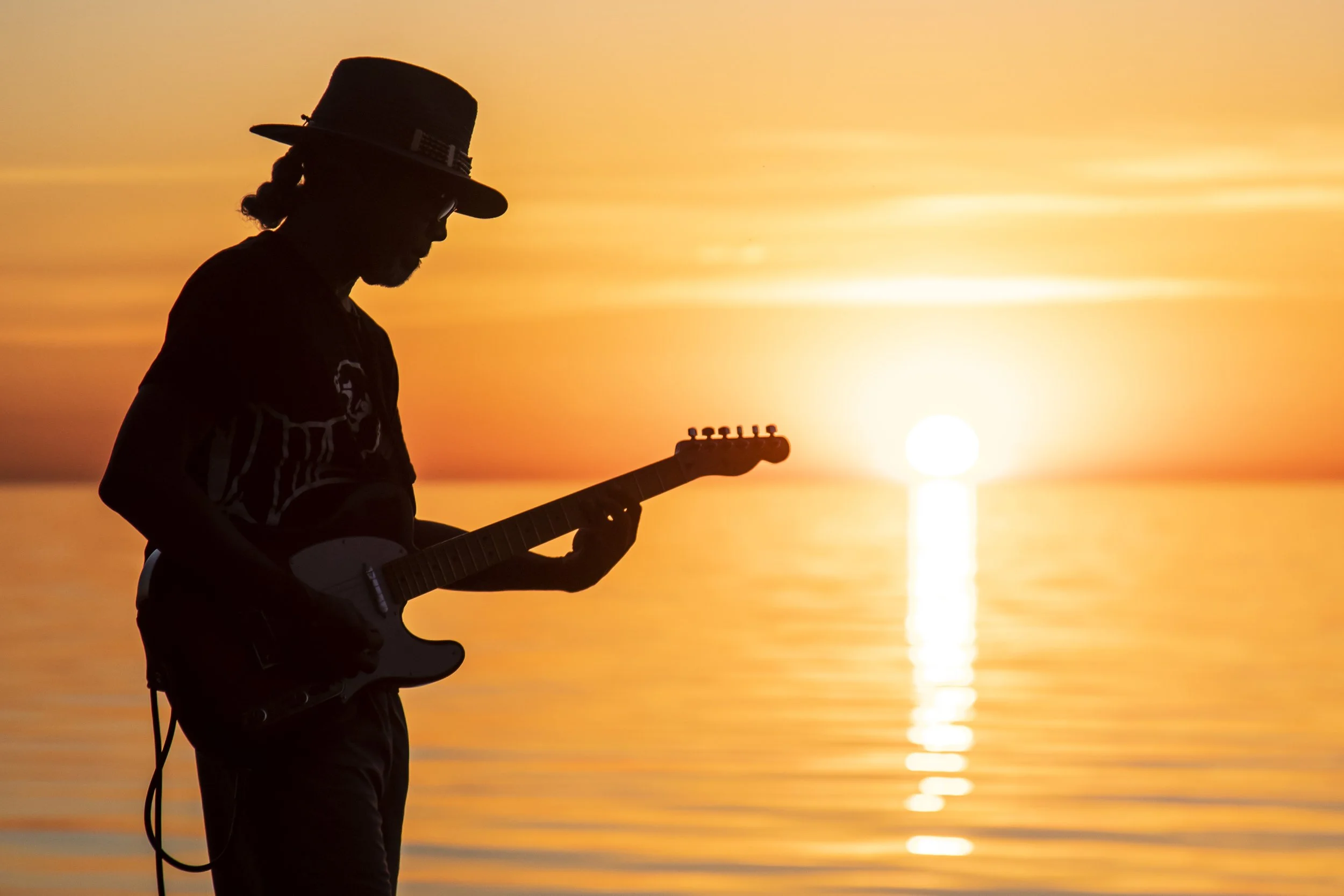  Chris Christmas, 70, of Portage Park, plays "Here Comes The Sun" by The Beatles as the sun rises over Lake Michigan near Foster Beach on the North Side, Friday morning, June 24, 2022. | Ashlee Rezin/Sun-Times      Chris Christmas is Chicago’s sunris