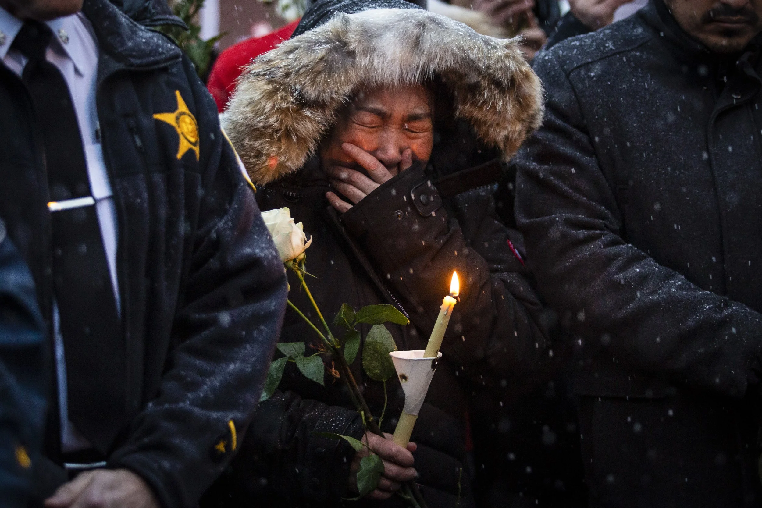  A woman cries as hundreds of mourners gather for a vigil in a parking lot in the 2000 block of South Wells Street in Chinatown, where Huayi Bian, 36, and Weizhong Xiong, 38, were shot to death, Wednesday, Feb. 12, 2020.   Bian and Xiong were killed 