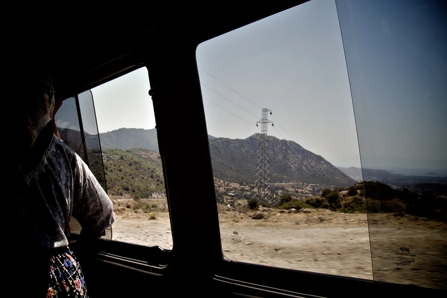 Woman in Turkey travelling by minibus coach towards Bodrum from Yalikavak