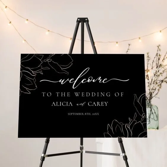 BLACK SIGN WHITE LETTERS W.FLORAL.jpg