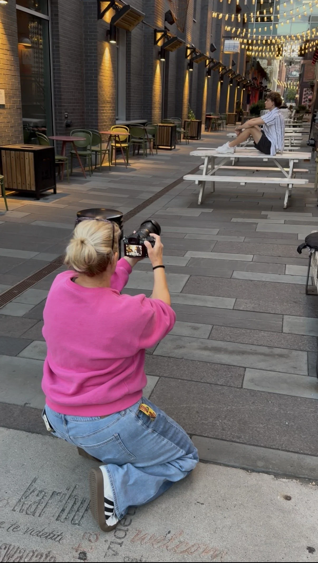 Jennie Bennett photographing a high school senior during a session, Castle Rock senior photographer serving Denver Metro