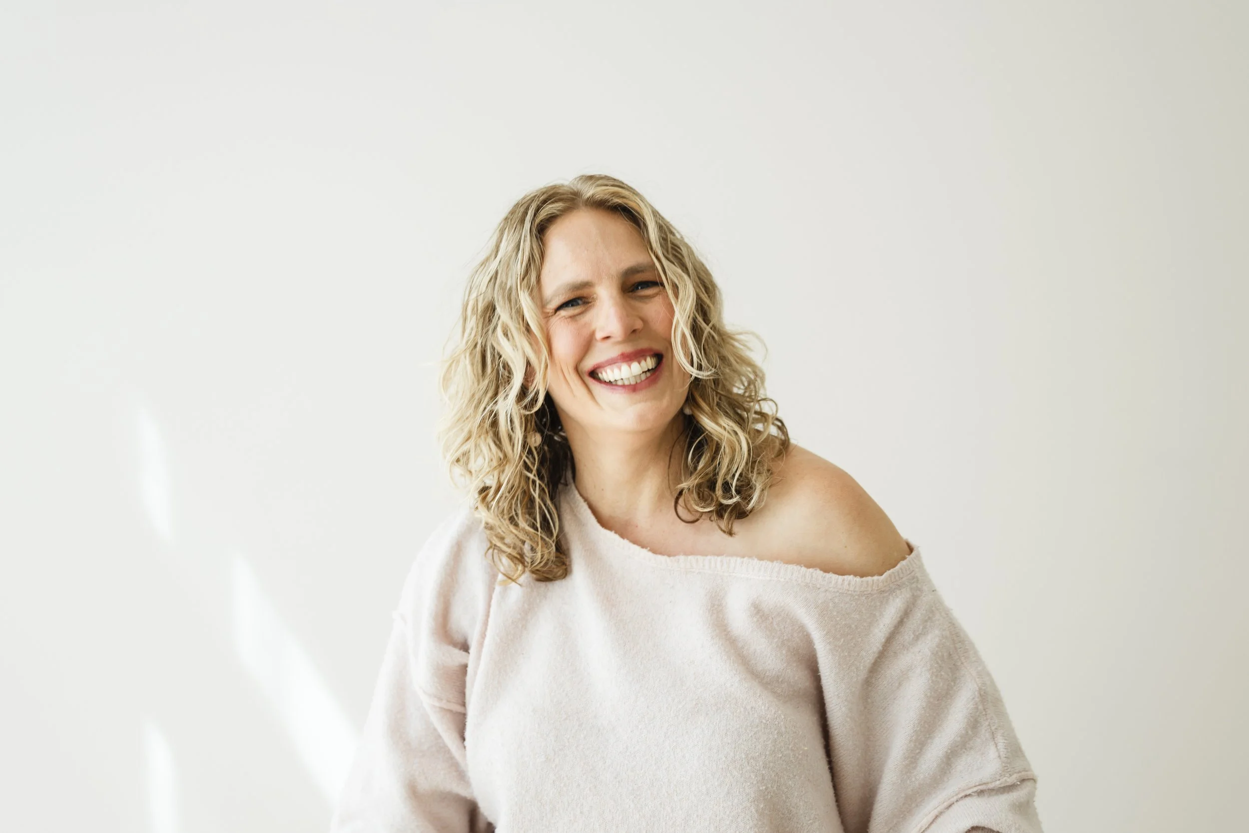 Jennie Bennett, Denver senior photographer, laughing during a branding session