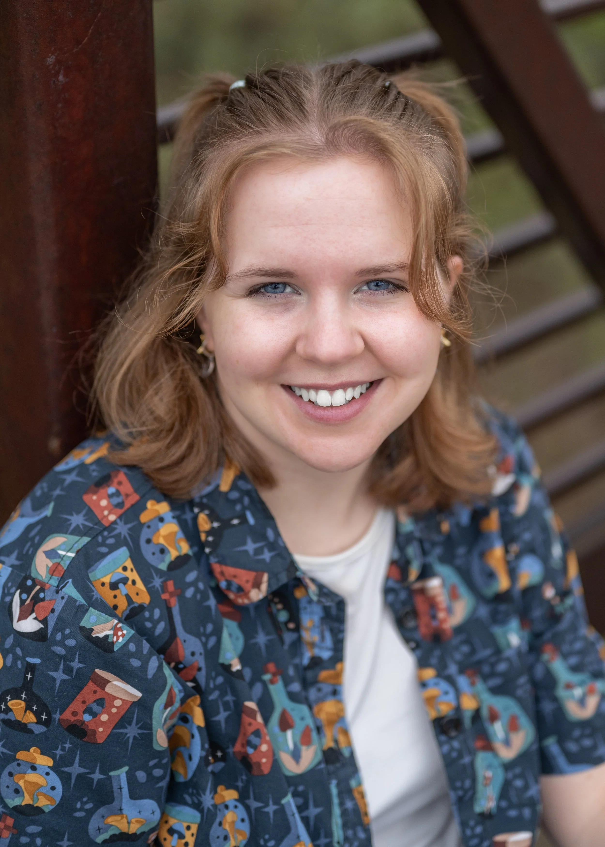 Smiling high school senior girl in a colorful patterned shirt, natural and relaxed Parker area senior portrait.