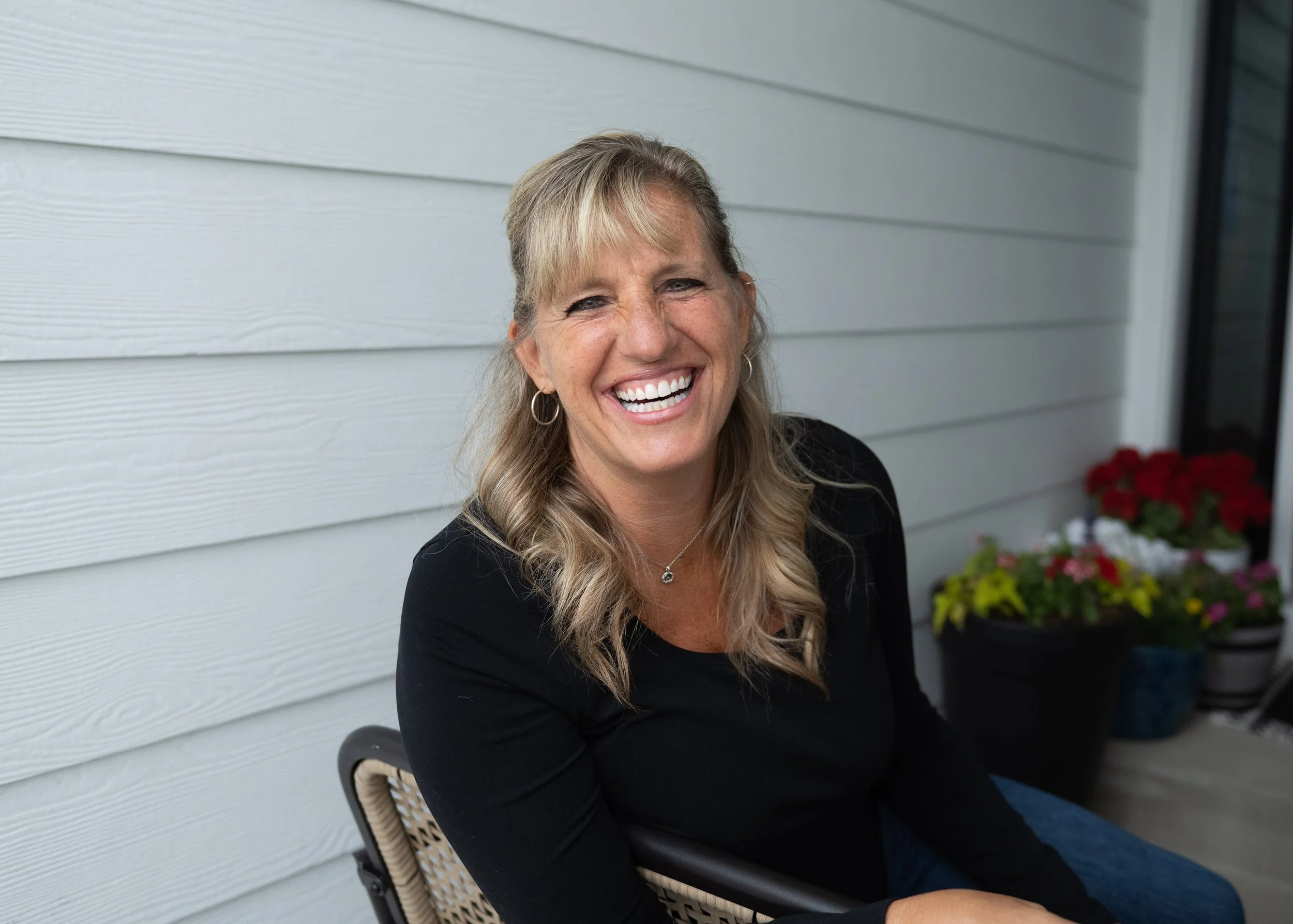 •	Woman laughing during on-location headshot session in Denver Colorado