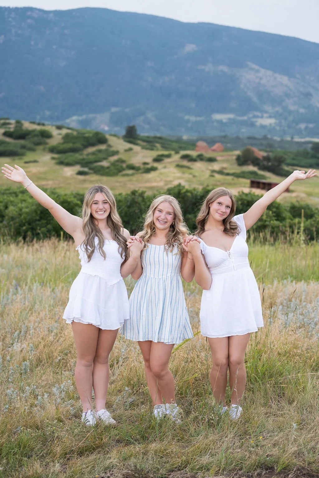 Three high school senior girls laughing in a Colorado mountain meadow — Denver senior rep team photographer Jennie Bennett Photography