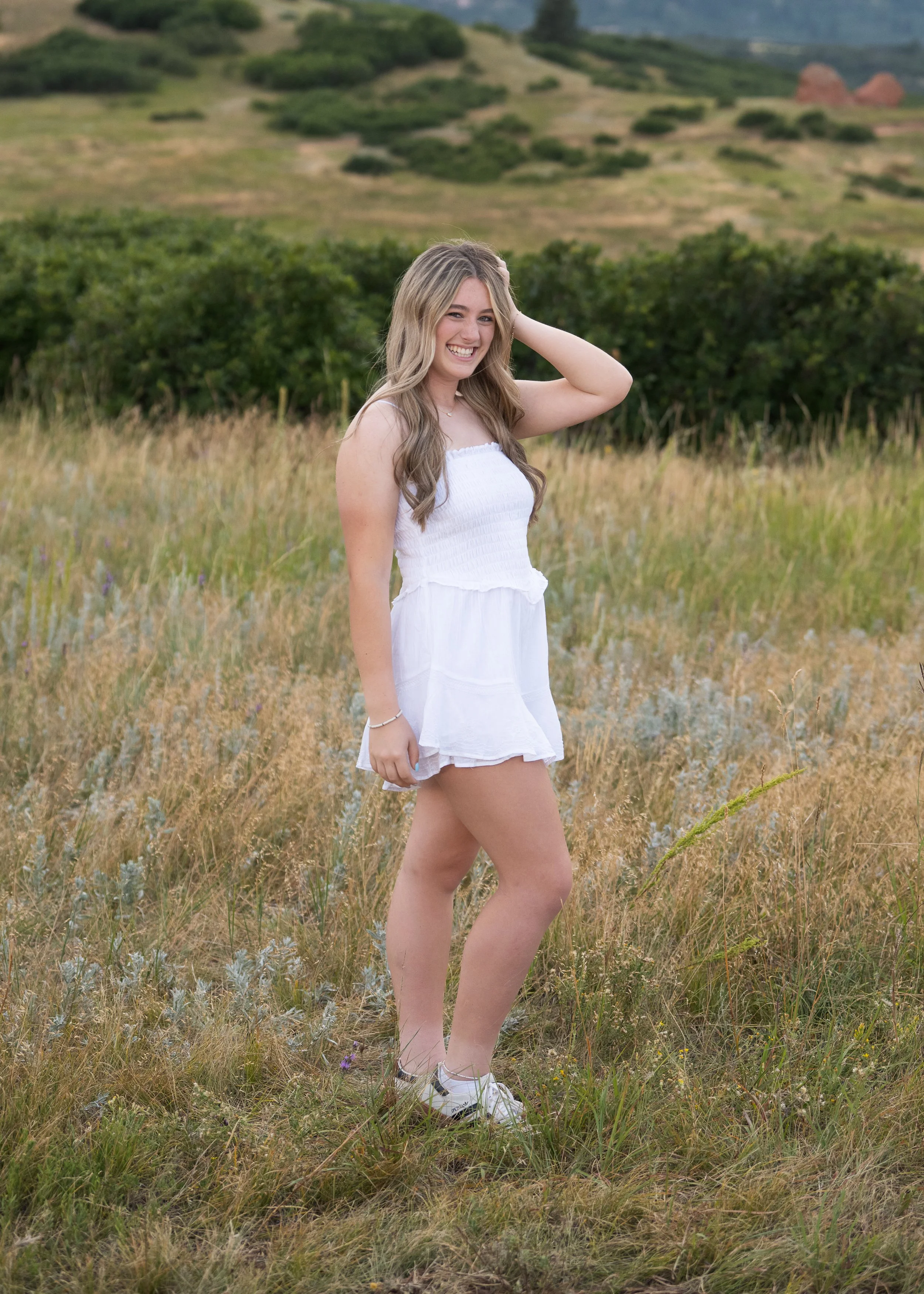High school senior girl portrait in a Colorado golden field photographed by Jennie Bennett Photography
