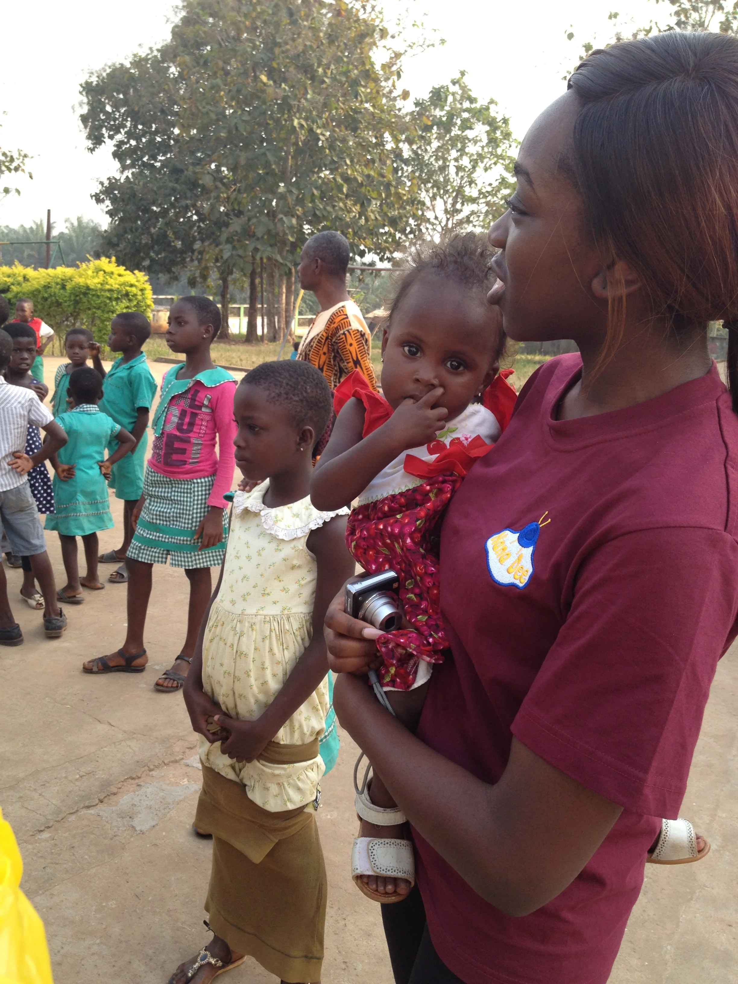  Team member looks on as children play in the playground. 