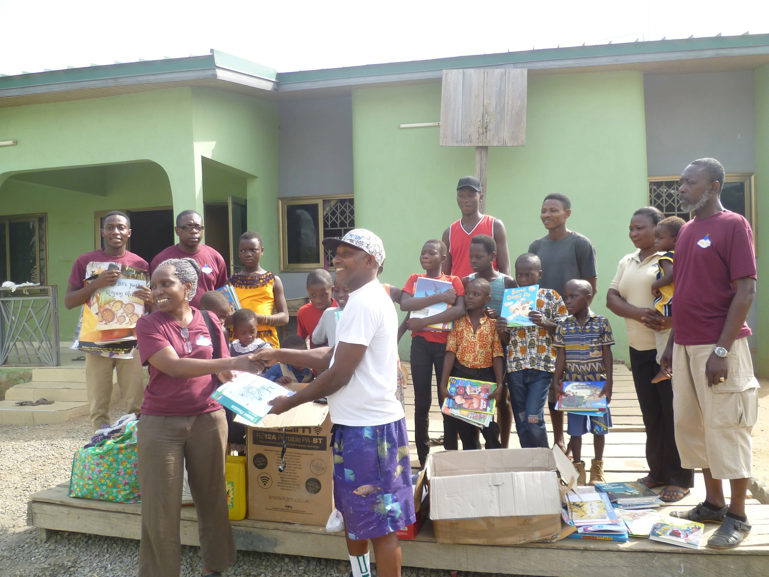  Nana Dee presenting books to orphanage director. 