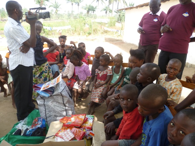 Local press captures the distribution of more gifts donated to the children.