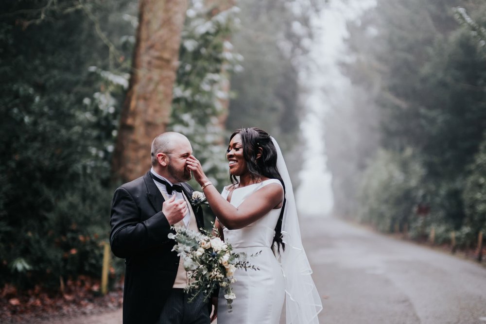  Meisha playfully touches Patrick’s face as they pose for photos on a country lane. 