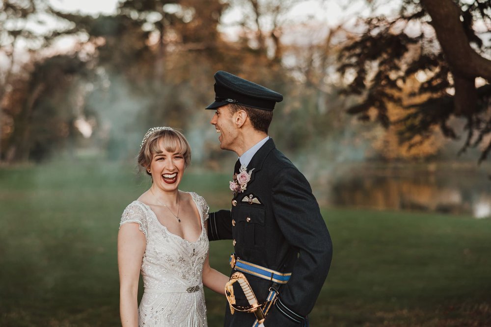  Emma and Sam are in fits of laughter outside, in the background are faint clouds of the smoke bombs. 