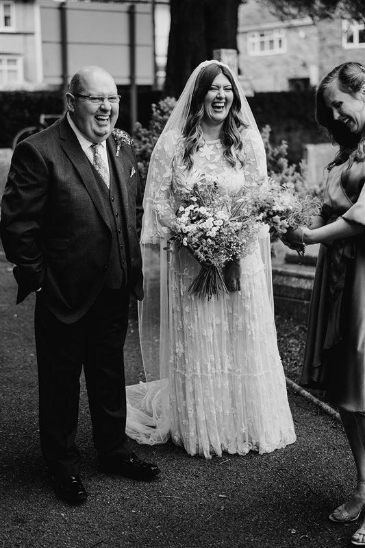  Gemma and her Dad stand at the top of the aisle with wide smiles. 