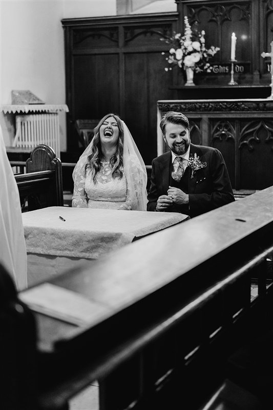  Gemma and Nick sit for the signing of the register. Both look overjoyed and are laughing. 