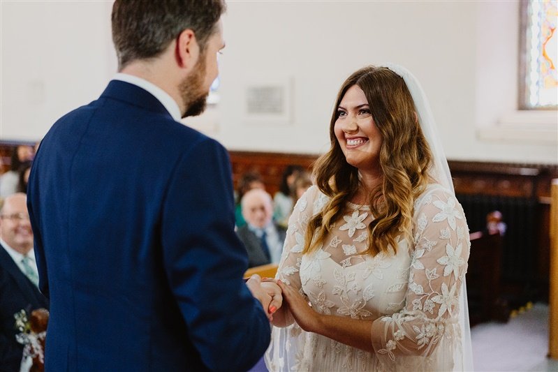  Nick and Gemma hold hands and look at each other during their vows in the church ceremony.  