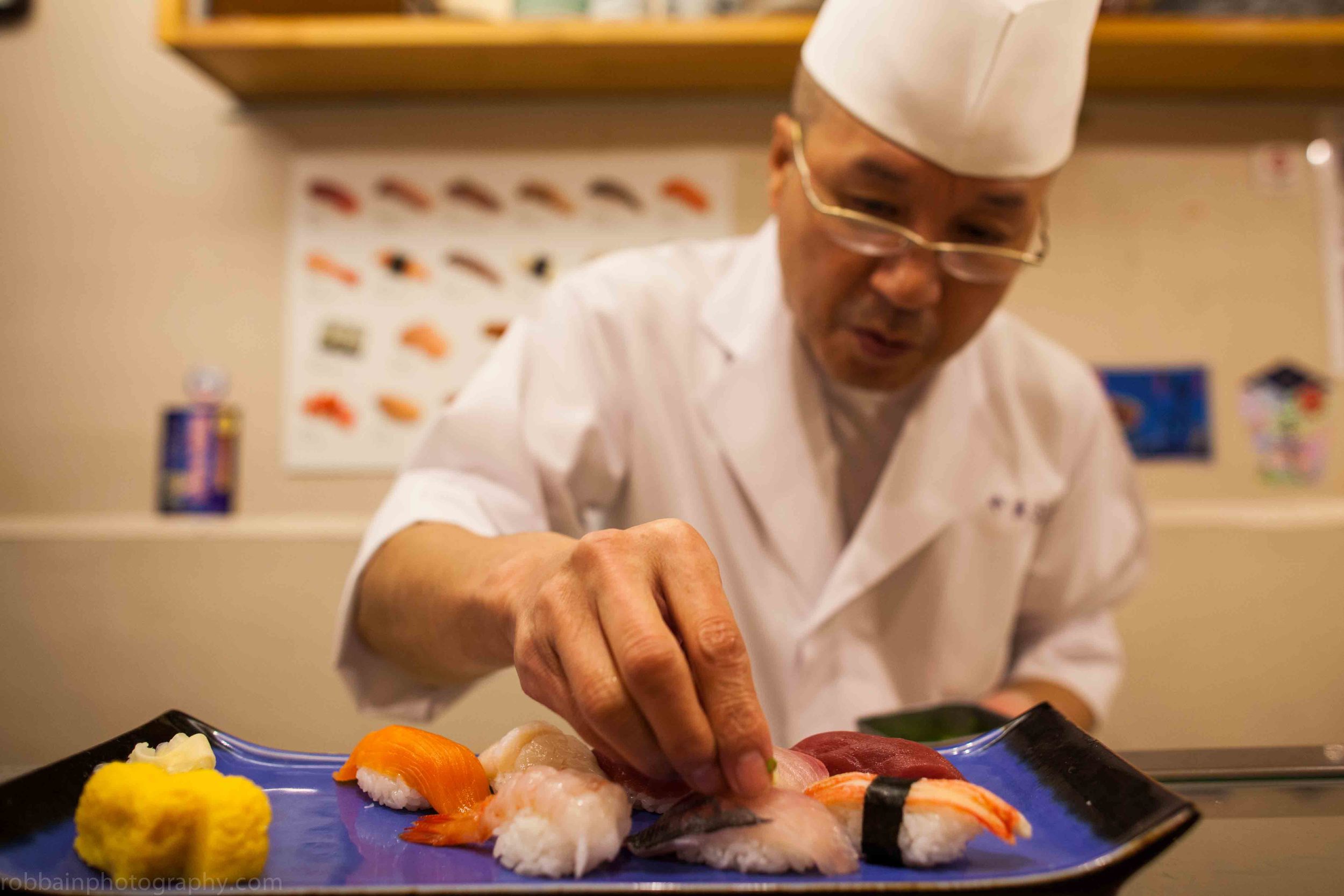 Photo 18. Sushi chef arranging dish.jpg