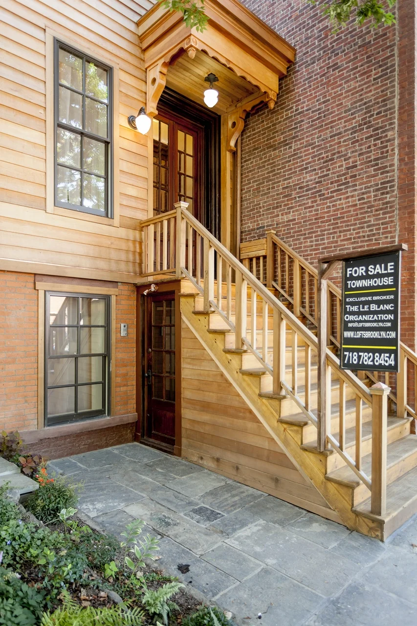 Exterior of renovated and restored Victorian row house. Clad in cedar and copper, period overhang designed and built, original style Brooklyn bluestone pavers.