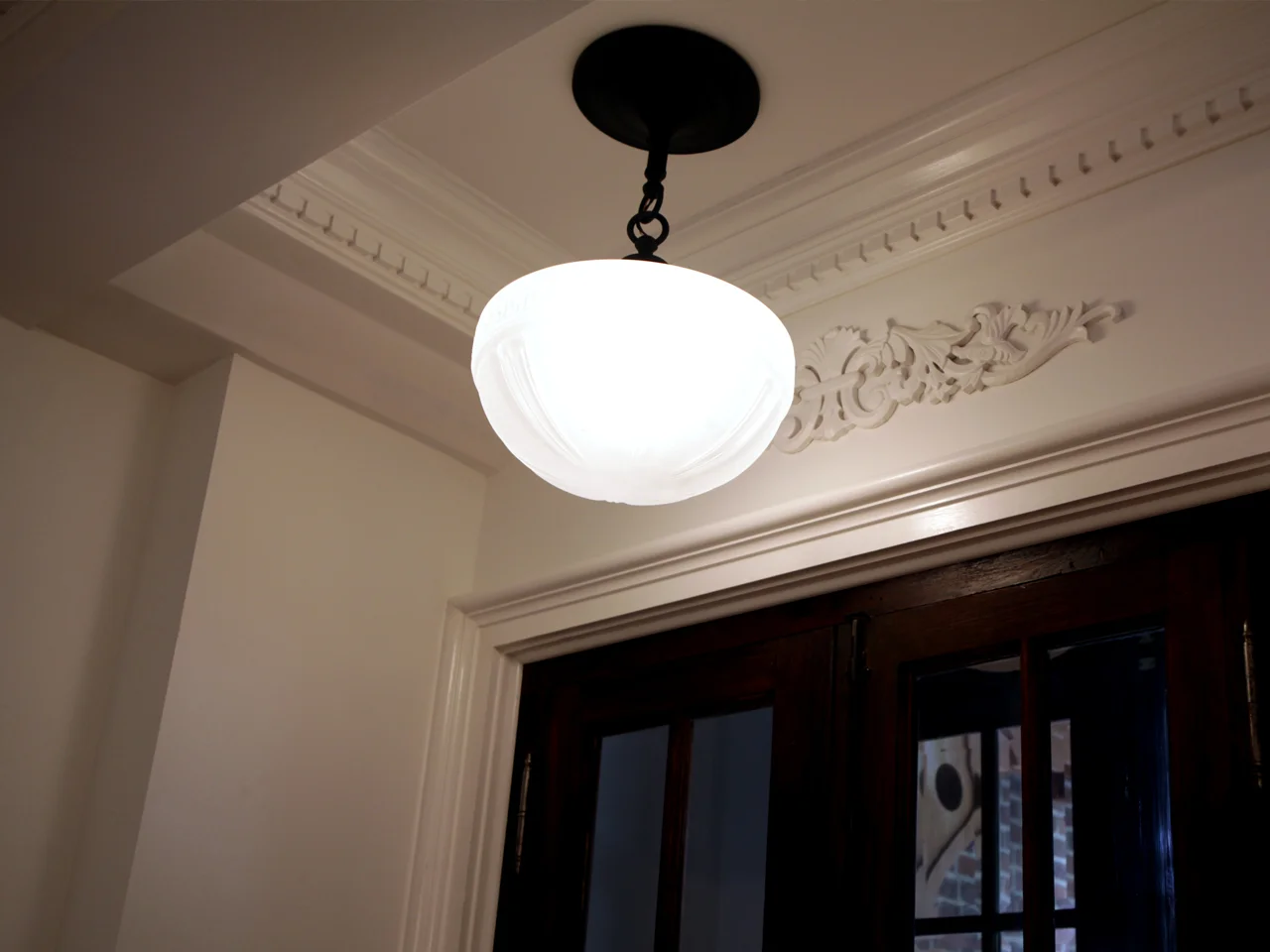 Foyer entrance recreated period lighting, wall rosette, Brooklyn Brownstone restoration.