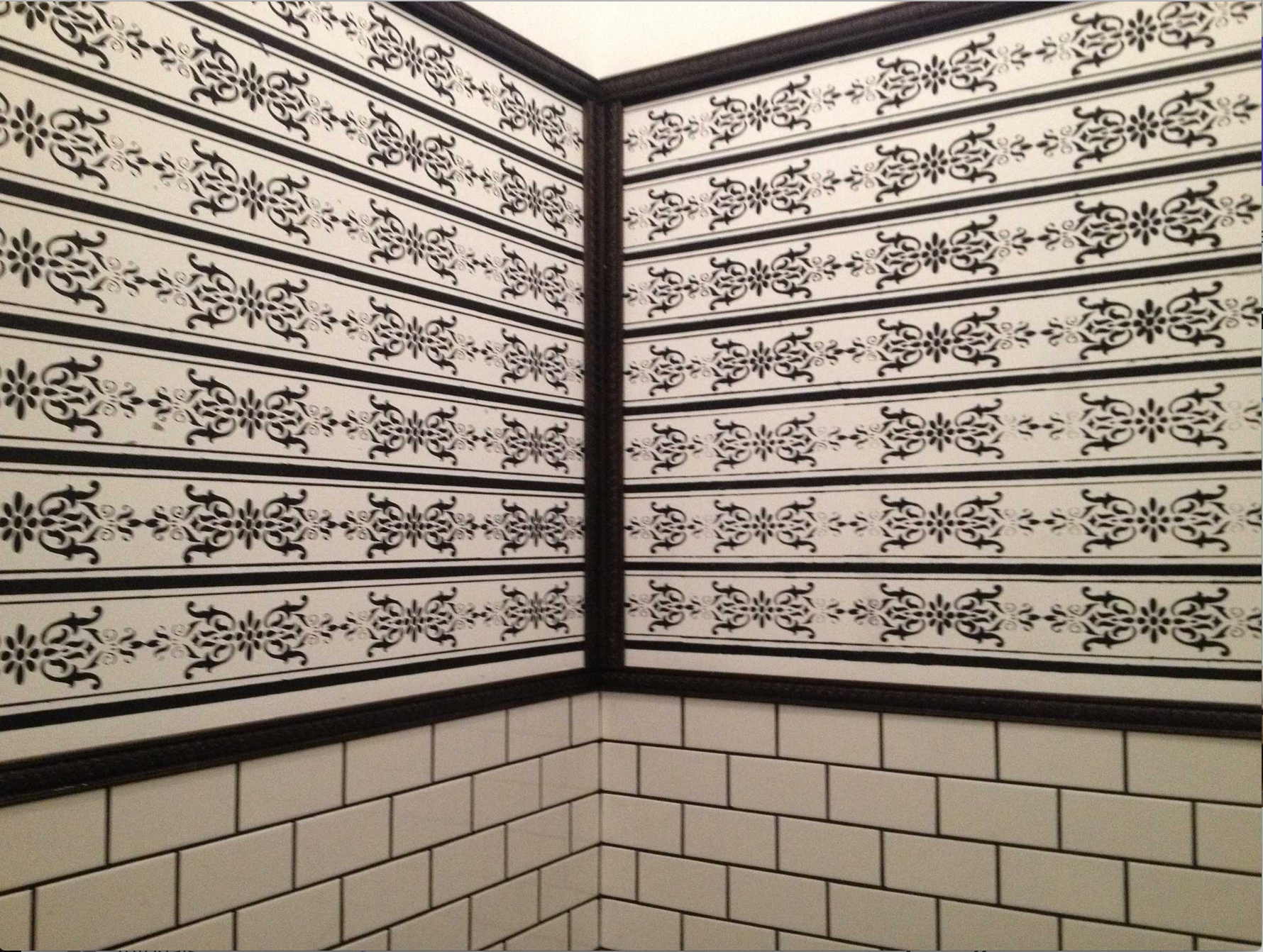 Restaurant bathroom stencils and tile with wood trim