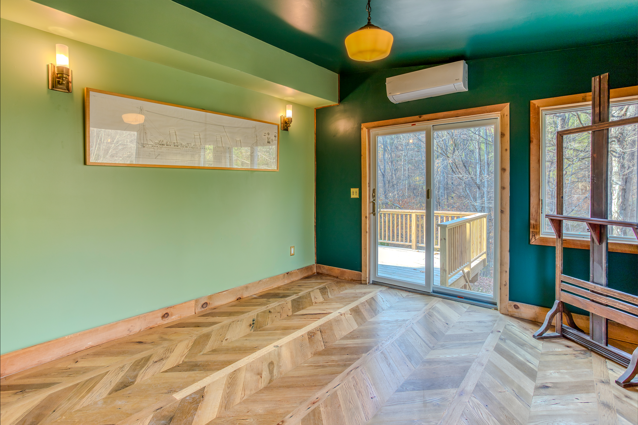 Floor of reclaimed antique oak cut into chevron pattern.