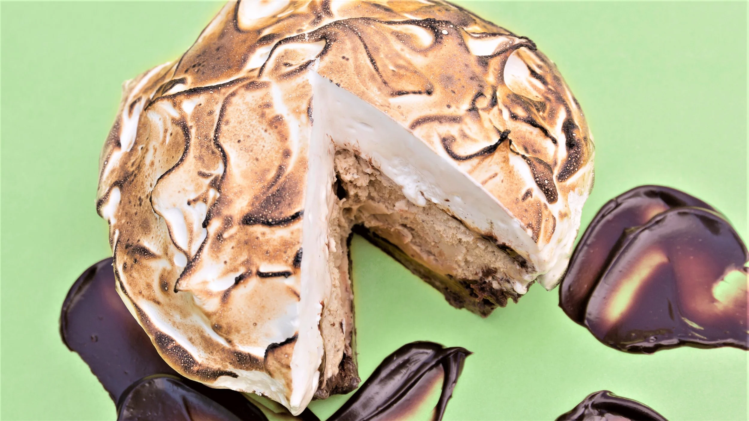 Our gelato pies are made with brownie crumb crust, a layer of gelato, a layer of fudge sauce, and a layer of torched marshmallow meringue. 