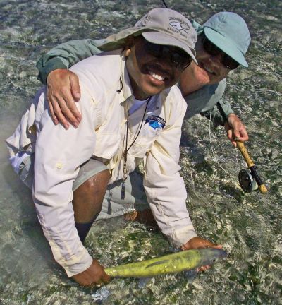 Fly Fishing guides with a golden bonefish caught fly fishing the bonefish flats of Turneffe Atoll