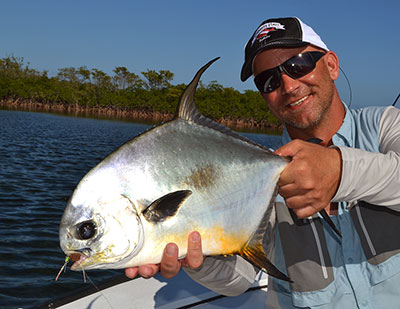 Fly Fishing for permit in Belize is enjoyed by this happy angler