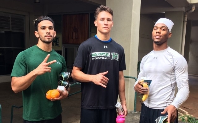   2017 UH Football Players: Slotback John Ursua, quarterback Cole McDonald and cornerback Rojesterman Farris II enjoying our oranges and bananas.  