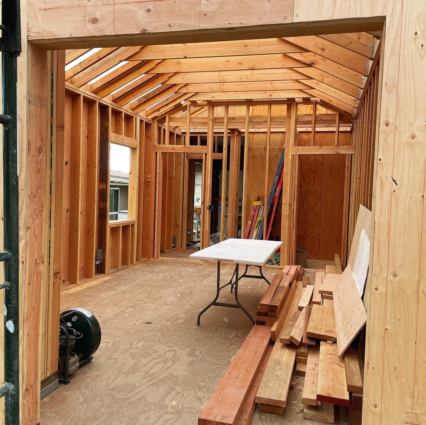 Mastering studio build update: we have walls! The center wall has offset studs. The front walls (between the storage closet and machine room) are angled. The ceiling is 10 feet tall (before flooring and tongue and groove). Rough electrical started th