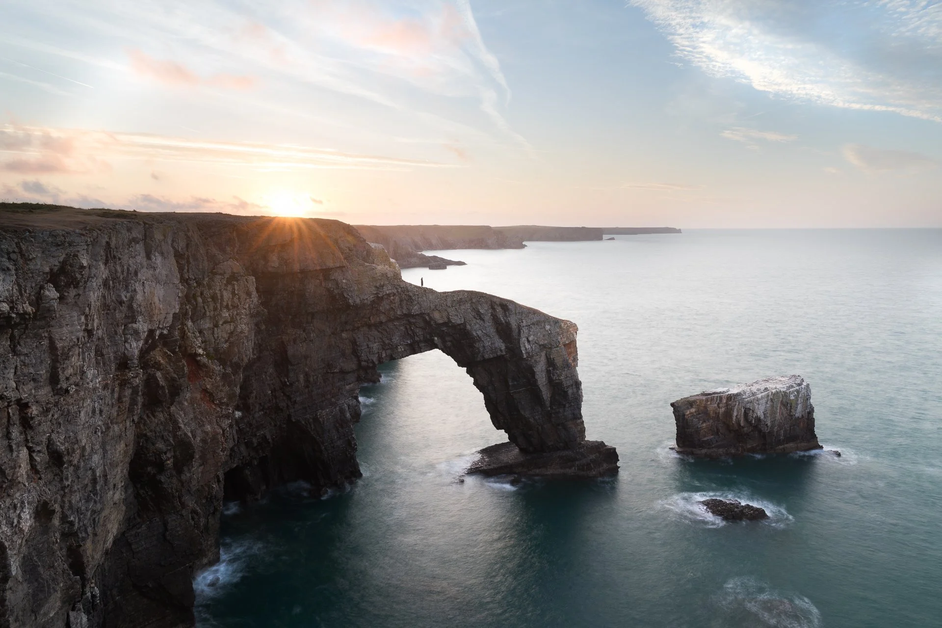 green-bridge-of-wales-lone-figure-sunrise-pembrokeshire.jpg