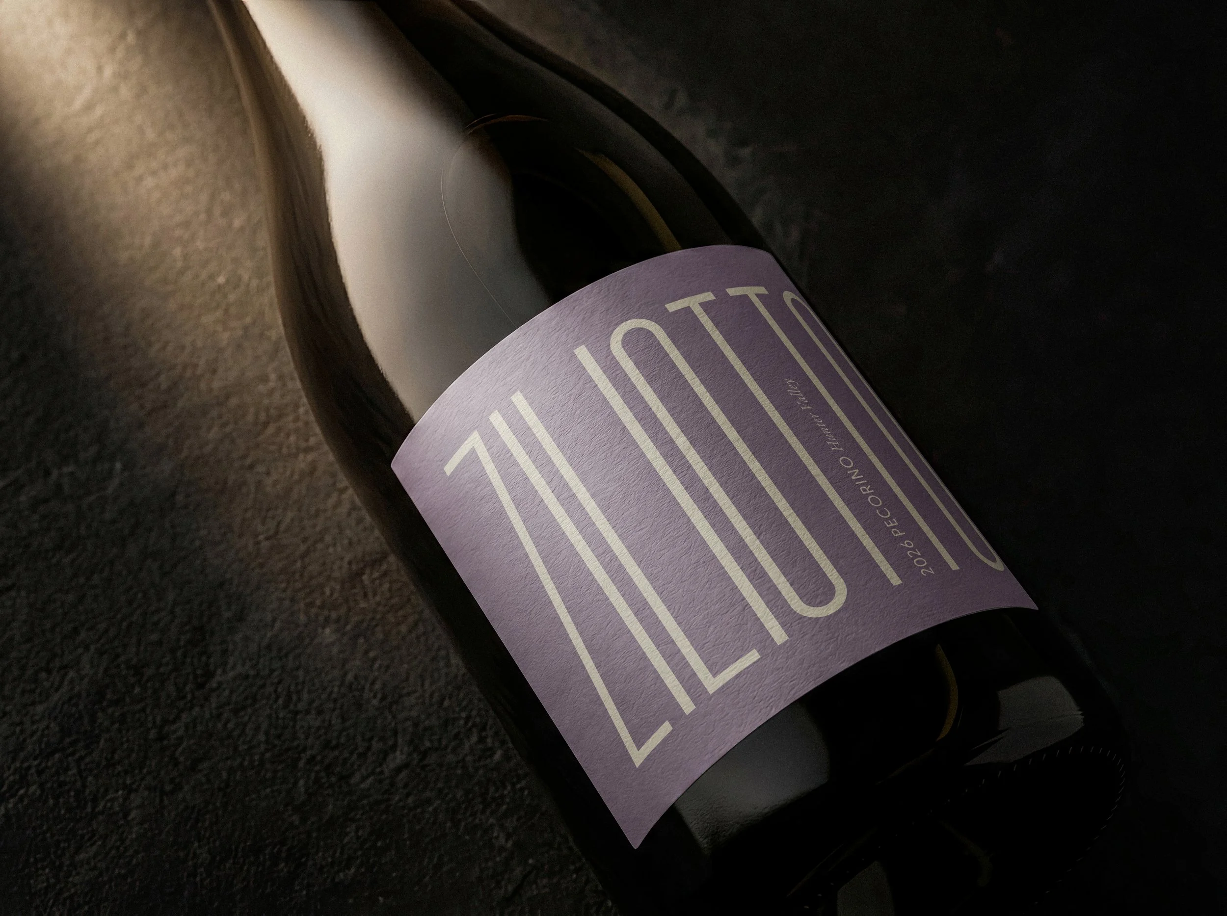 A dark wine bottle with a tan label that reads 'ZITO 10' and additional text about Nero D'Avola wine from 2023, positioned against a dark background. |