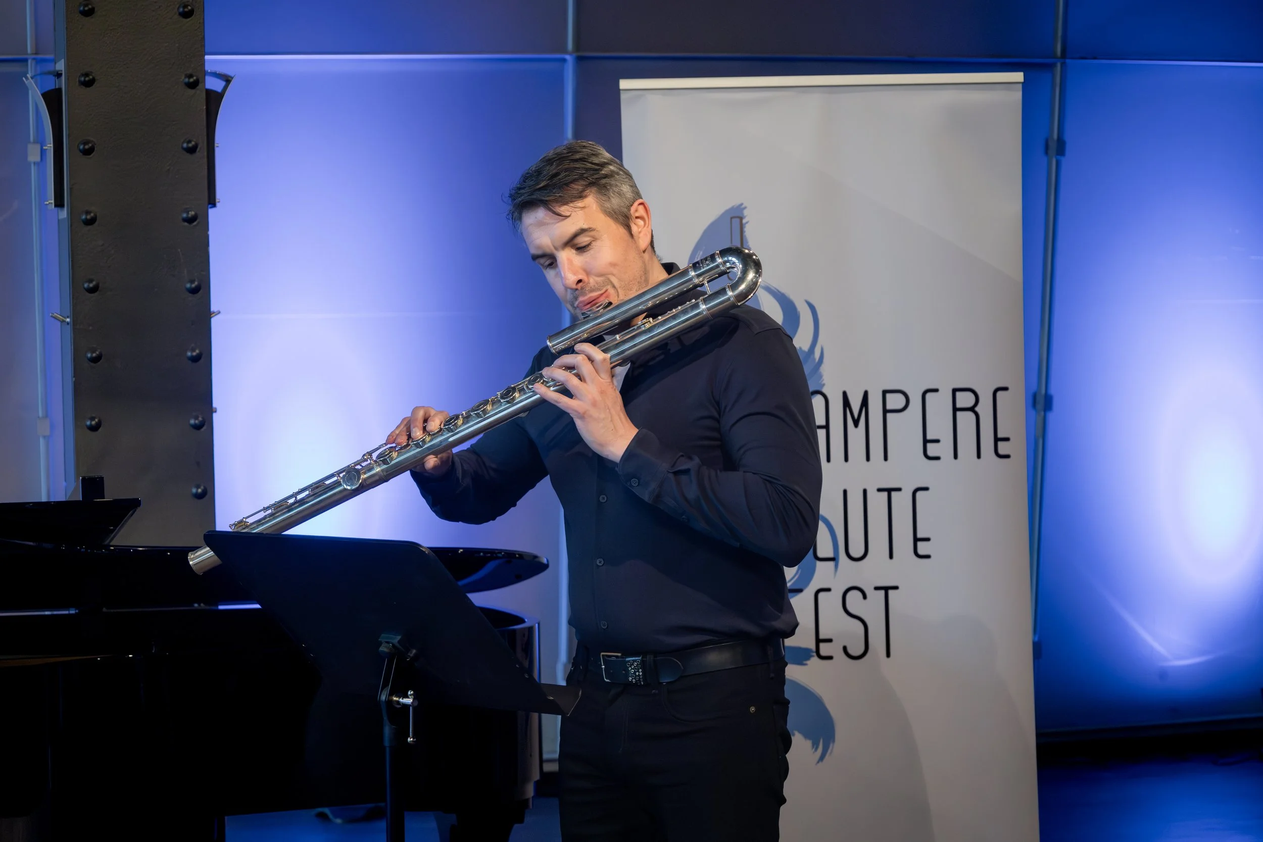 Gareth McLearnon playing bass flute in concert