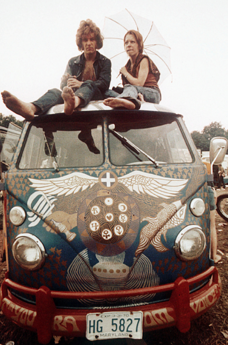 Concertgoers sit on the roof of a Volkswagen Bus at the Woodstock festival in Bethel, N.Y., in mid-August 1969. (Associated Press)